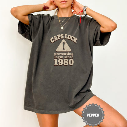 Dark grey t-shirt with "CAPS LOCK preventing login since 1980" text.