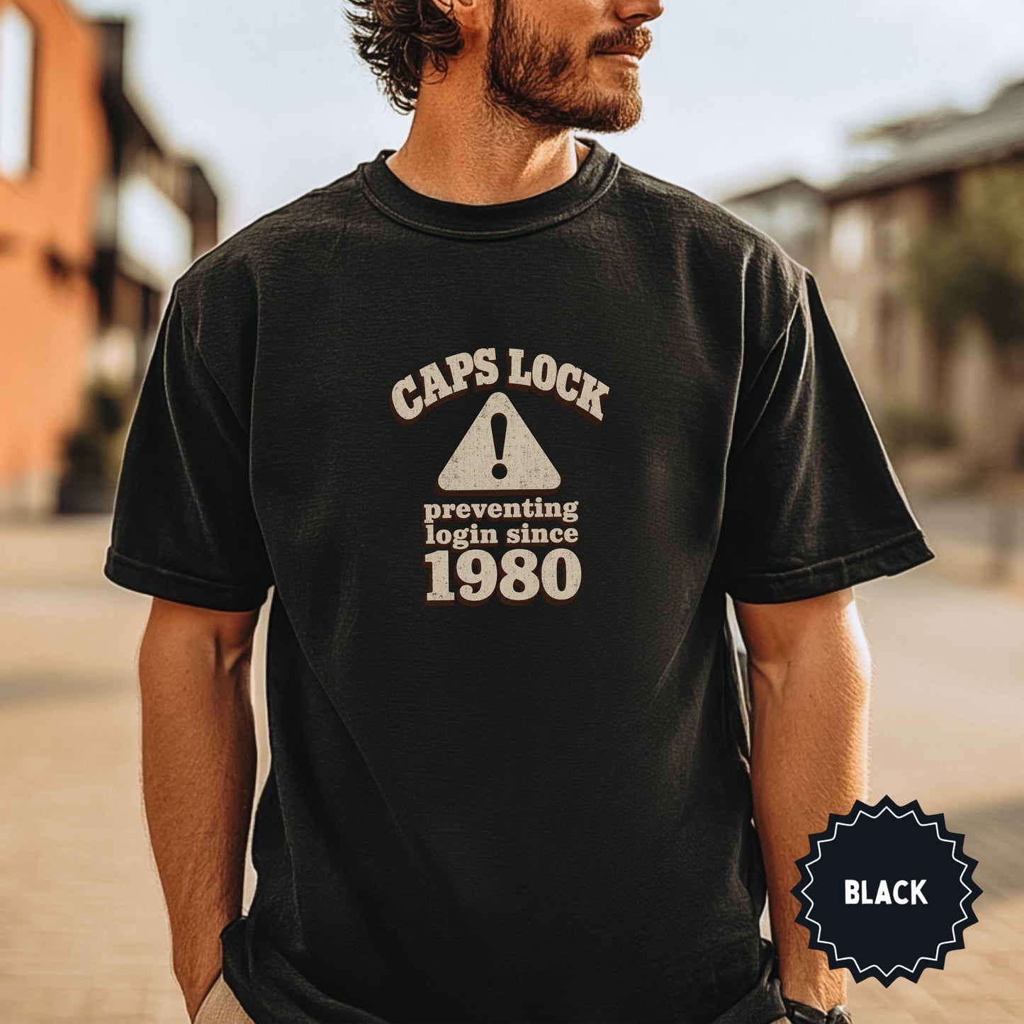 Black t-shirt with "CAPS LOCK preventing login since 1980" text and warning sign.
