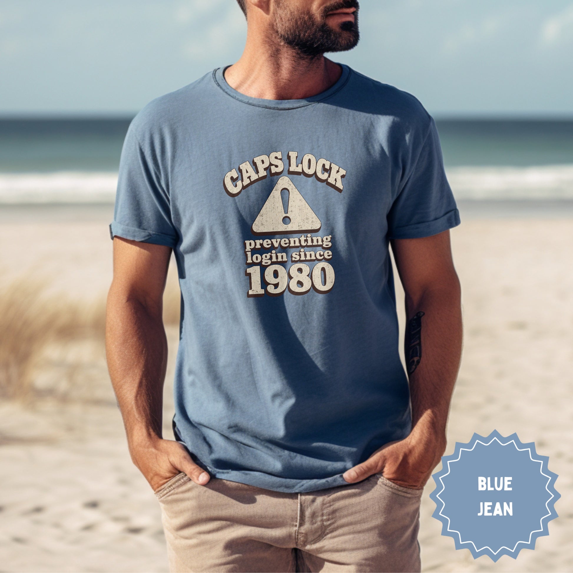 Blue t-shirt with "CAPS LOCK preventing login since 1980" text.