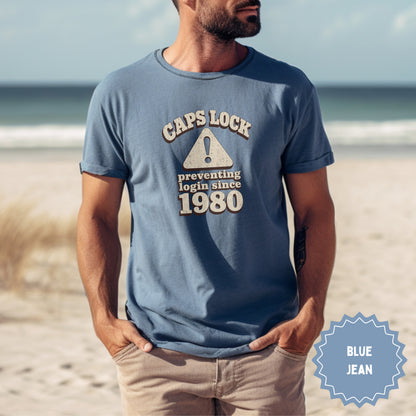 Blue t-shirt with "CAPS LOCK preventing login since 1980" text.