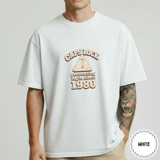 White t-shirt with "CAPS LOCK preventing login since 1980" text and warning sign.